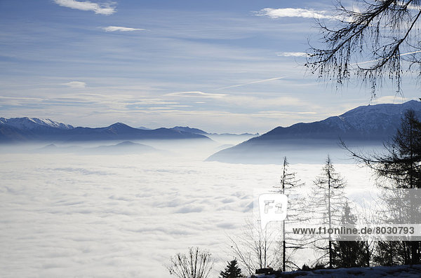 Billows of fog rolling over the landscape Locarno ticino switzerland