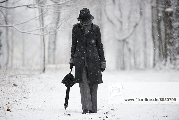 A woman walking down a snowy path in winter Locarno ticino switzerland