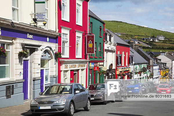 Colourful buildings and parked cars along a street Dingle county kerry ireland