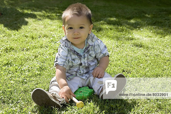 Chinese-Canadian Boy Sitting In The Sunshine With His Toy  Ontario  Canada