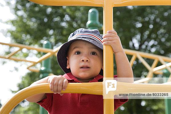Young Asian-Caucasian Boy Climbing Playground Equipment  Ontario Canada