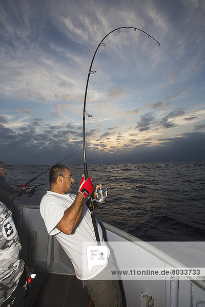 Man fishing gets a bite on his line Corpus christi texas usa