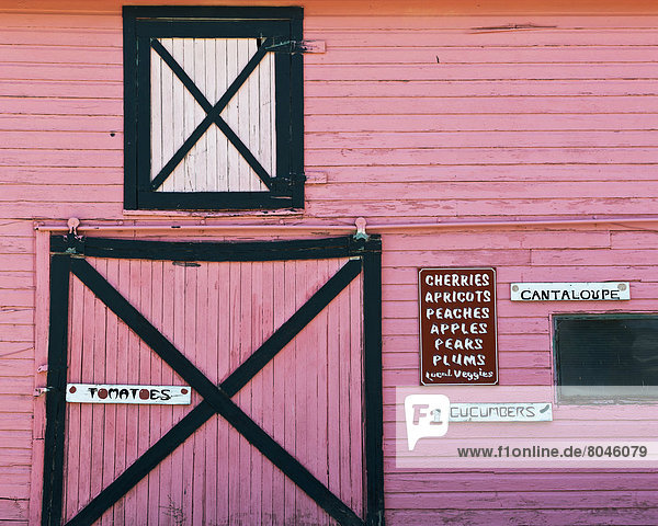 Pink barn farm store selling fresh local fruit and vegetables Palisade Colorado USA