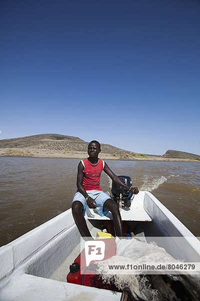 Man sitting in fishing boat in Central Island National Park  Lake Turkana  Turkana  Kenya
