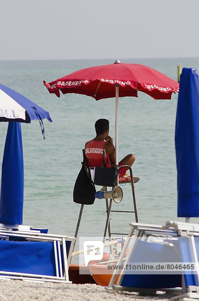 Lifeguard on watch on high chair and sun umbrella  Porto Sant'Elpidio  Marche  Italy