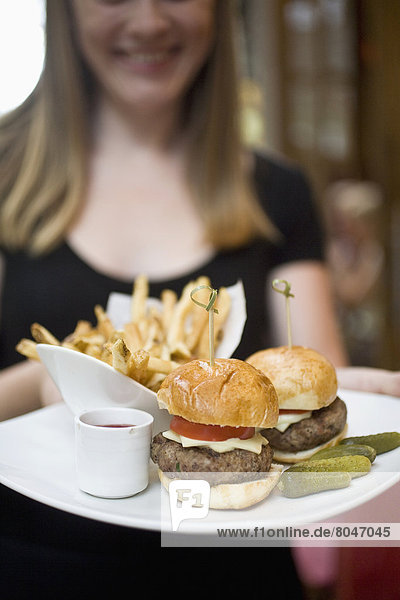 USA  New York State  Waitress with fries and hamburger in Cinema Restaurant  New York City