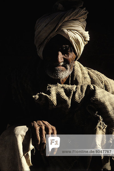 Portrait of old beggar man