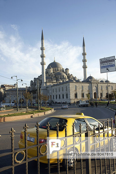 Turkey  Istanbul  Exterior of Mosque Yeni Camii(1597) and yellow taxi  Eminonou