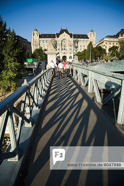 Tourists crossing Szechenyi Chain Bridge over Danube river  Budapest  Hungary