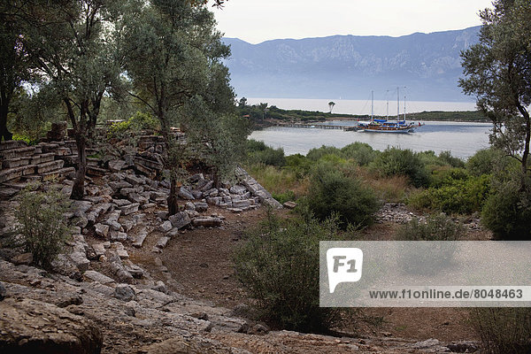 Turkey  Gokava Gulf  behind Cleopatra Beach  Sedir (Cedrai) Island  Gulet boat seen from ruins of amphitheater
