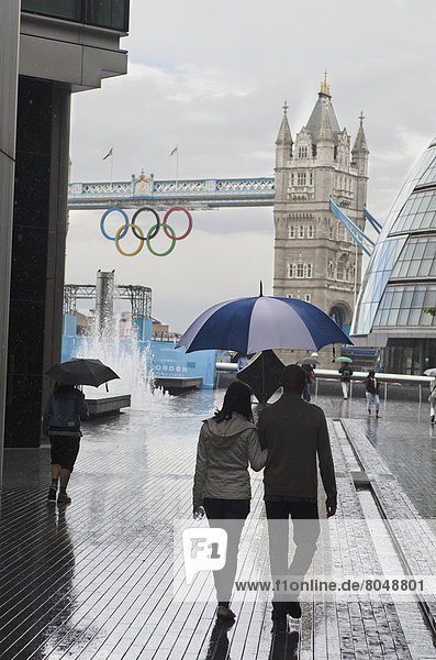 View of Tower Bridge and Mayor of London building with people walking in rain  London  England  United Kingdom