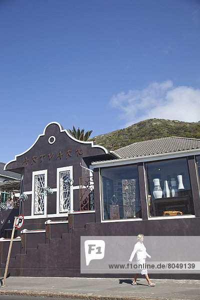 South Africa  Cape Town  View of street with shop and passing tourist  Kalk Bay