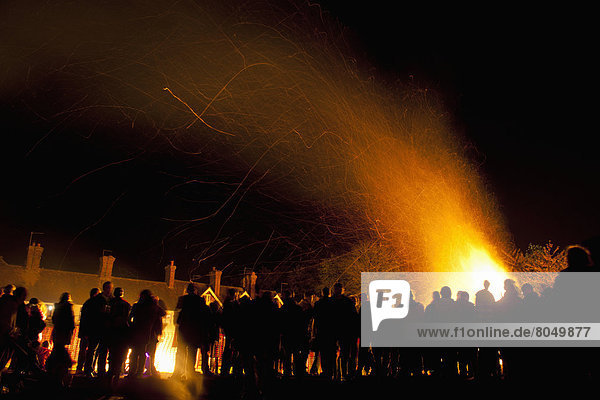 People in front of large bonfire at Bonfire Night  Newick  East Sussex  England  UK
