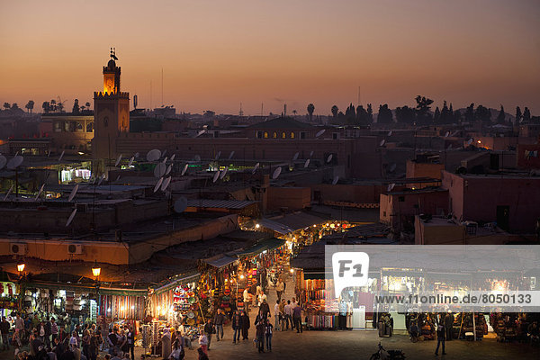 Looking over entrance to souks at dusk at edge of Djemaa El Fna  Marrakesh  Morocco