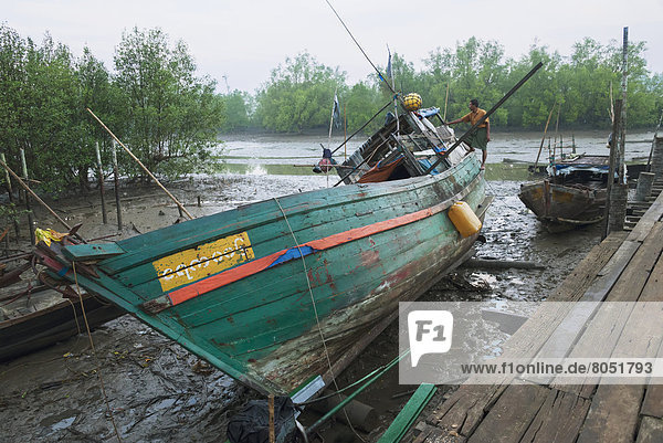 Wooden fishing boat at low tide  Nag Yoke Kaung  Irrawaddyi Division  Myanmar (Burma)