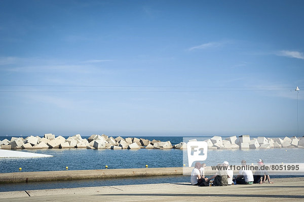 Festival goers relaxing next to the sea at Primavera Sound music festival  Parc del Forum  Barcelona  Spain