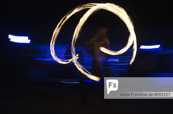 Man juggling fire at night  Reading  Berkshire  UK