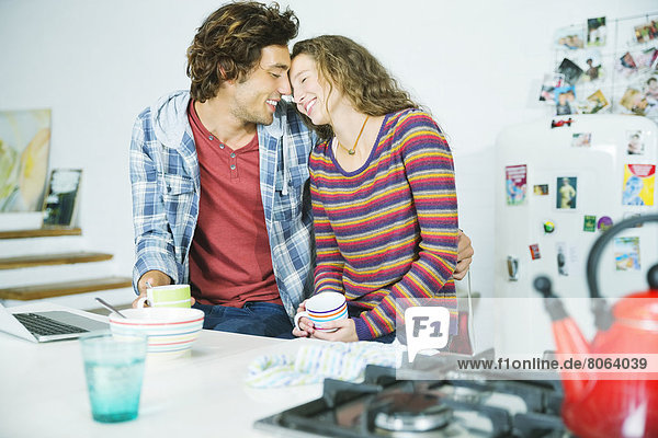 Couple relaxing together in kitchen
