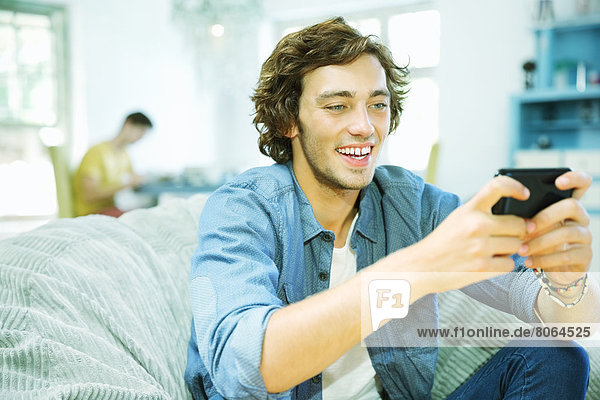 Man using cell phone in beanbag chair