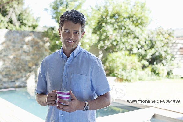 Man drinking cup of coffee outdoors