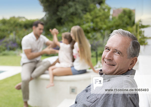 Older man smiling outdoors