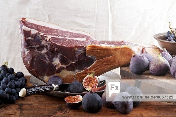 A leg of Parma ham,  figs and blue grapes