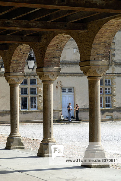 'Two teenagers playing violin in the yard of the Louis XI Chateau  La Cote-Saint-Andre (38). Rhone-Alpes region  France. Way of St.James or St.James' Way (Santiago de Compostella)  ''Voie de Geneve''  route from Geneva to Le Puy-en-Velay  Way of St James (St James' Way or Santiago de Compostela)'