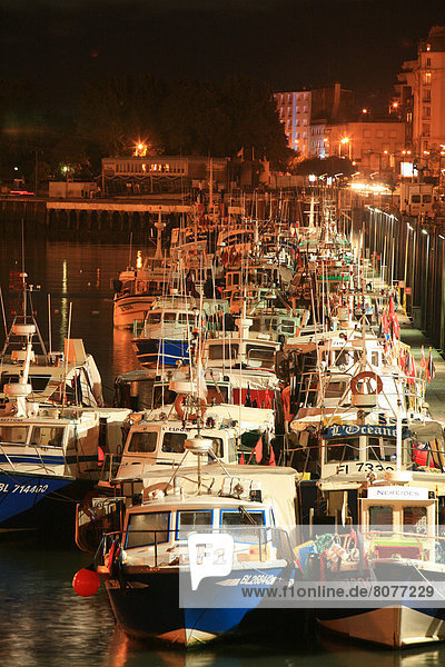 Fishing boats alongside the quay in the harbour of Boulogne-sur-Mer  at nightfall. 2007/08/28
