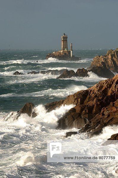 'The ''Pointe du Raz'' headland and its two lighthouses  ''La Vieille'' and ''La Plate''  with a choppy sea breaking against the cliff and Cap Sizun (headland) in the background.'