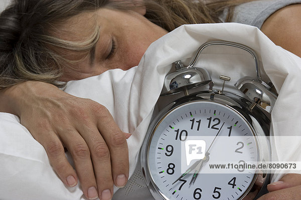 Sleeping woman  alarm clock