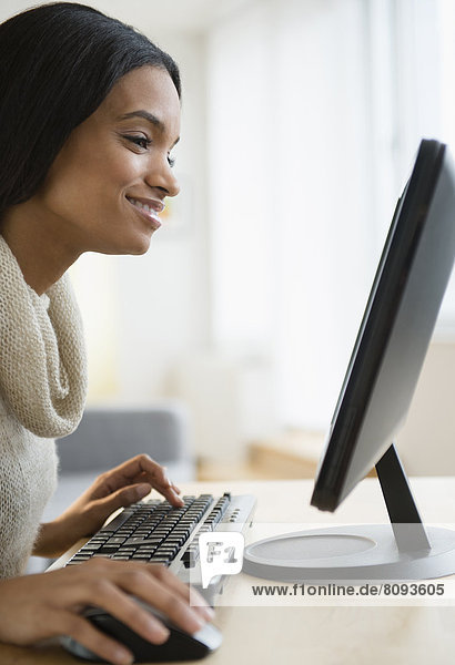 Mixed race woman using computer