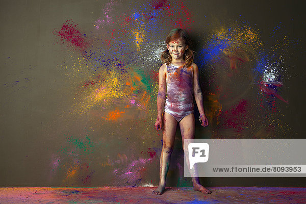Caucasian girl playing with paint