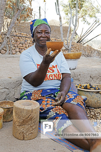 Woman of the Kapsiki ethnic group manufacturing bowls made of clay  cow dung and goat dung