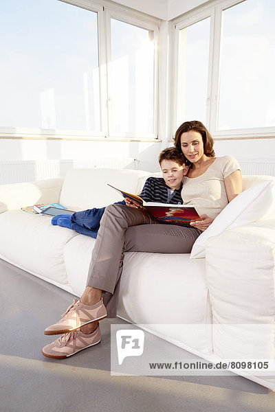 Mother and son reading on a sofa