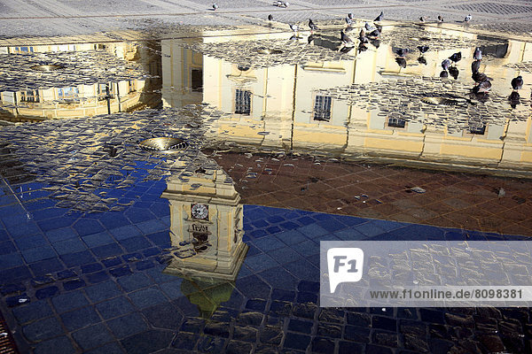 Catholic Garrison Church reflected in play of water at the Grand Square