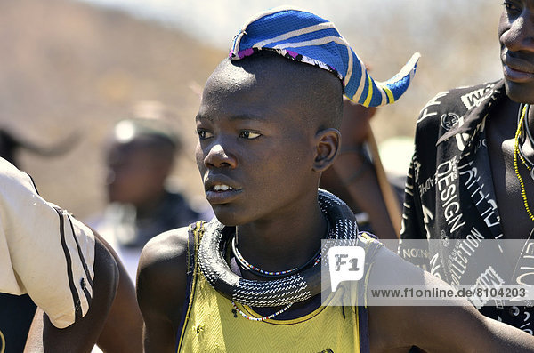 Young Himba man wearing a traditional headdress  cap in the form of a cattle horn