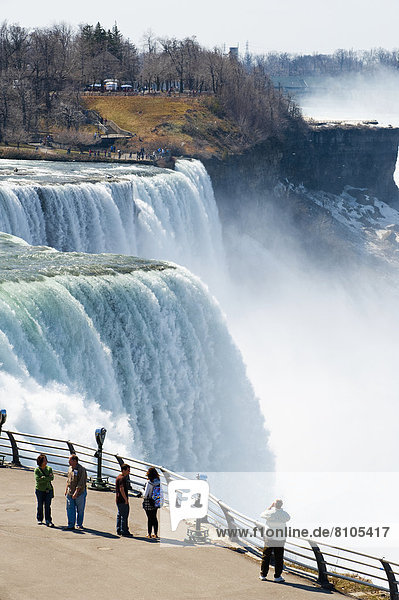 Tourists Enjoying The View Of Niagara Falls  Ontario And New York Border  Canada And United States Of America
