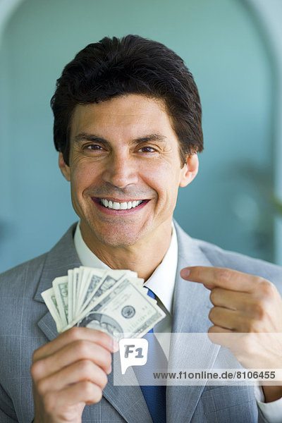 Businessman Smiling And Holding Money