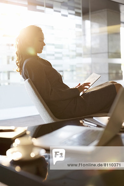 Businesswoman using digital tablet in office