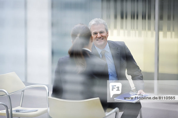 Smiling businessman talking to businesswoman