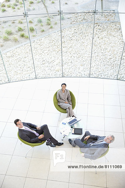 High angle portrait of business people meeting in lobby