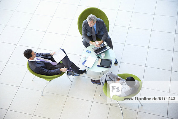 High angle view of business people meeting in lobby