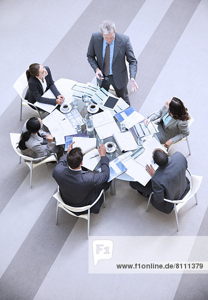 High angle view of businessman leading meeting
