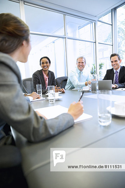 Smiling business people meeting in conference room