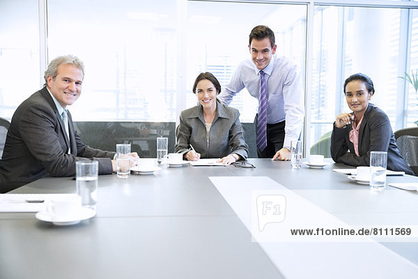 Portrait of smiling business people meeting in conference room