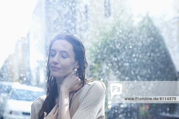 Serene woman standing in rain