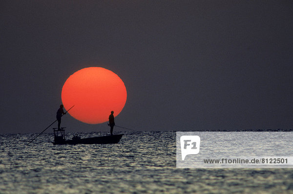 Boat Color Image Copy Space Florida Fishermen fishing Florida Keys Horizontal Outdoors Photography Sea Seascape Side View Silhouette Sky Sun Sunrise Two People USA Water Wave