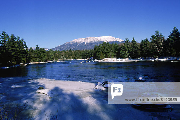 North America USA Maine Mountains Snow Sky Trees Lumber Pine Water River Forest Sunlight Shadow Ice Reflection Nobody Still Nature Landscape Winter Freezing Calm Outdoors Day Side View Distant Horizontal Color Image Photography