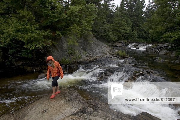 water stream one girl hiking nature forest beauty wilderness rain river horizontal color image waterfall outdoors daytime