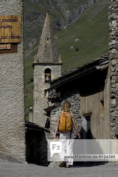 Stone building church girl bread Europe France Travel countryside alps teenager one person outdoors day color image vertical
